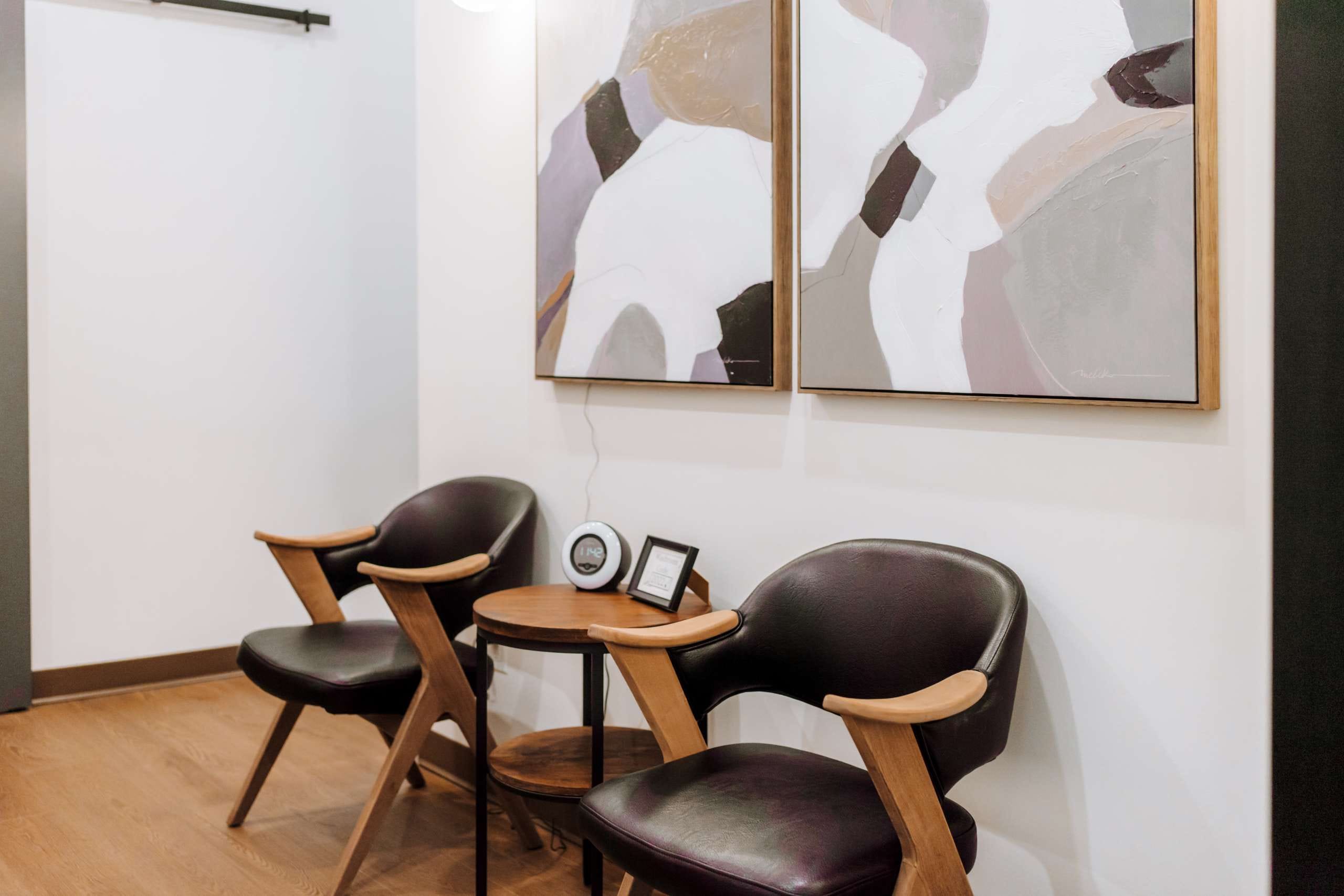 Waiting area at Vista Counselling in Langley, with two chairs and framed artwork